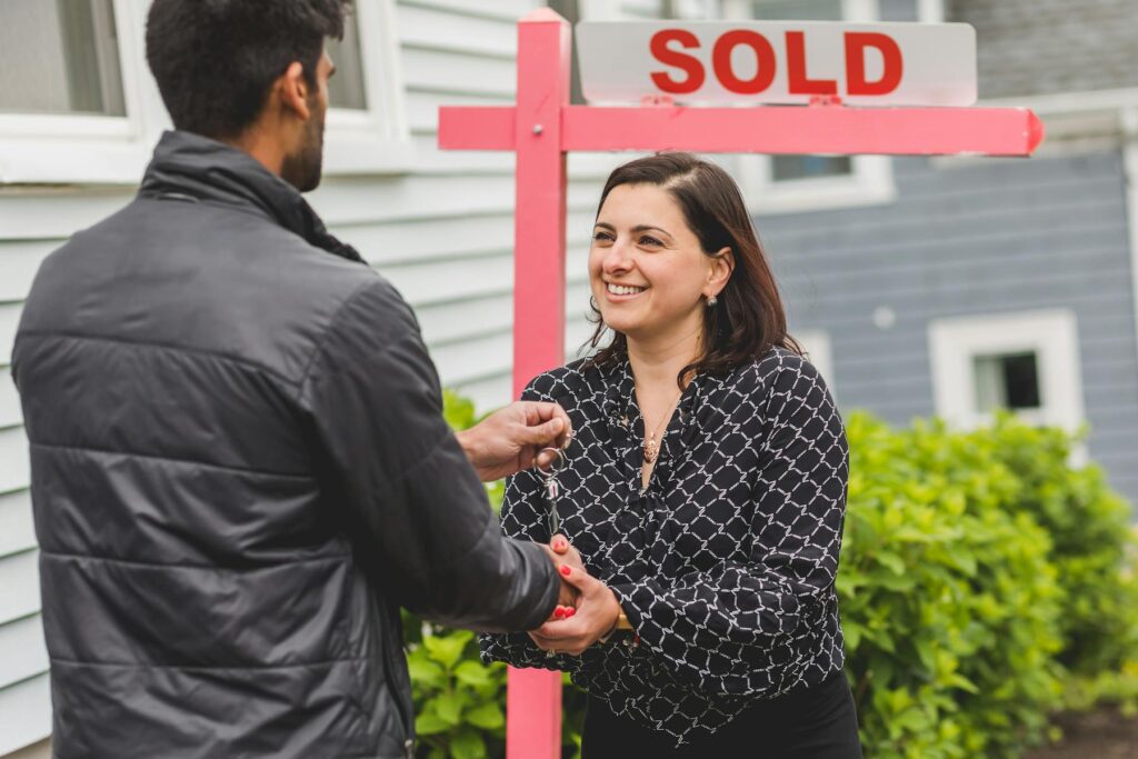 Real estate agent handing house keys to new homeowner